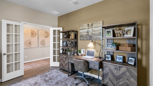 Warrior's Legacy model home secondary bedroom with an office desk and chair.