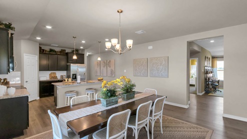Warrior's Legacy model home dining room with view of the kitchen.