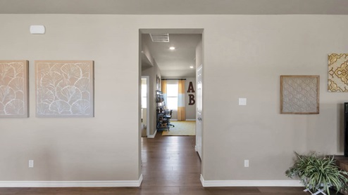 Warrior's Legacy model home living room with view of the hallway.