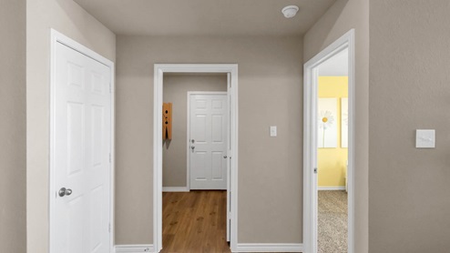 Warrior's Legacy model home hallway with view of the secondary bedroom.