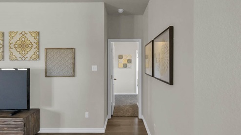 Warrior's Legacy model home living room with a view of the hallway.
