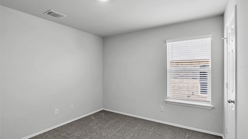 Lake Pointe Terrace secondary bedroom with carpeted flooring and window.