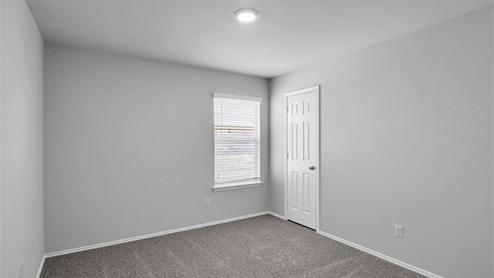 Lake Pointe Terrace secondary bedroom with carpeted flooring and window.