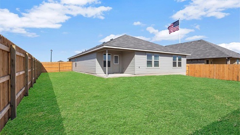 Lake Pointe Terrace model home back exterior with view of the backyard..