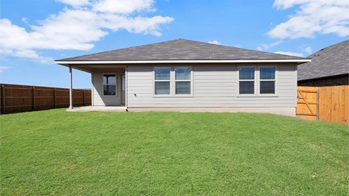 Lake Pointe Terrace model home back exterior with view of the backyard..