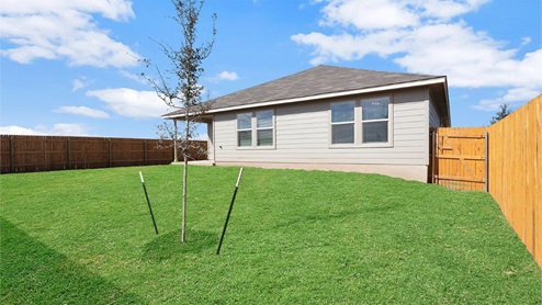 Lake Pointe Terrace model home back exterior with view of the backyard..