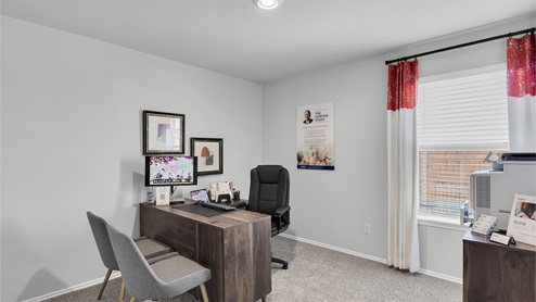 Lake Pointe Terrace secondary bedroom with carpeted flooring and view of backyard.