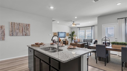 Lake Pointe Terrace kitchen island with view of open concept living room.