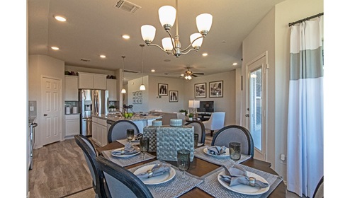 Creekside Hills model home dining room furnished with table and place settings.