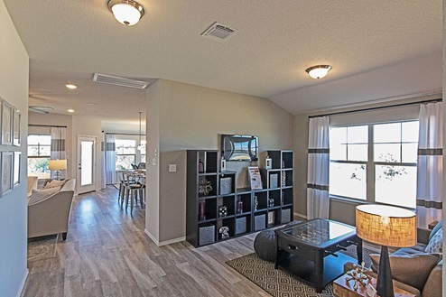 Creekside Hills model home game room with windows and vinyl plank flooring.