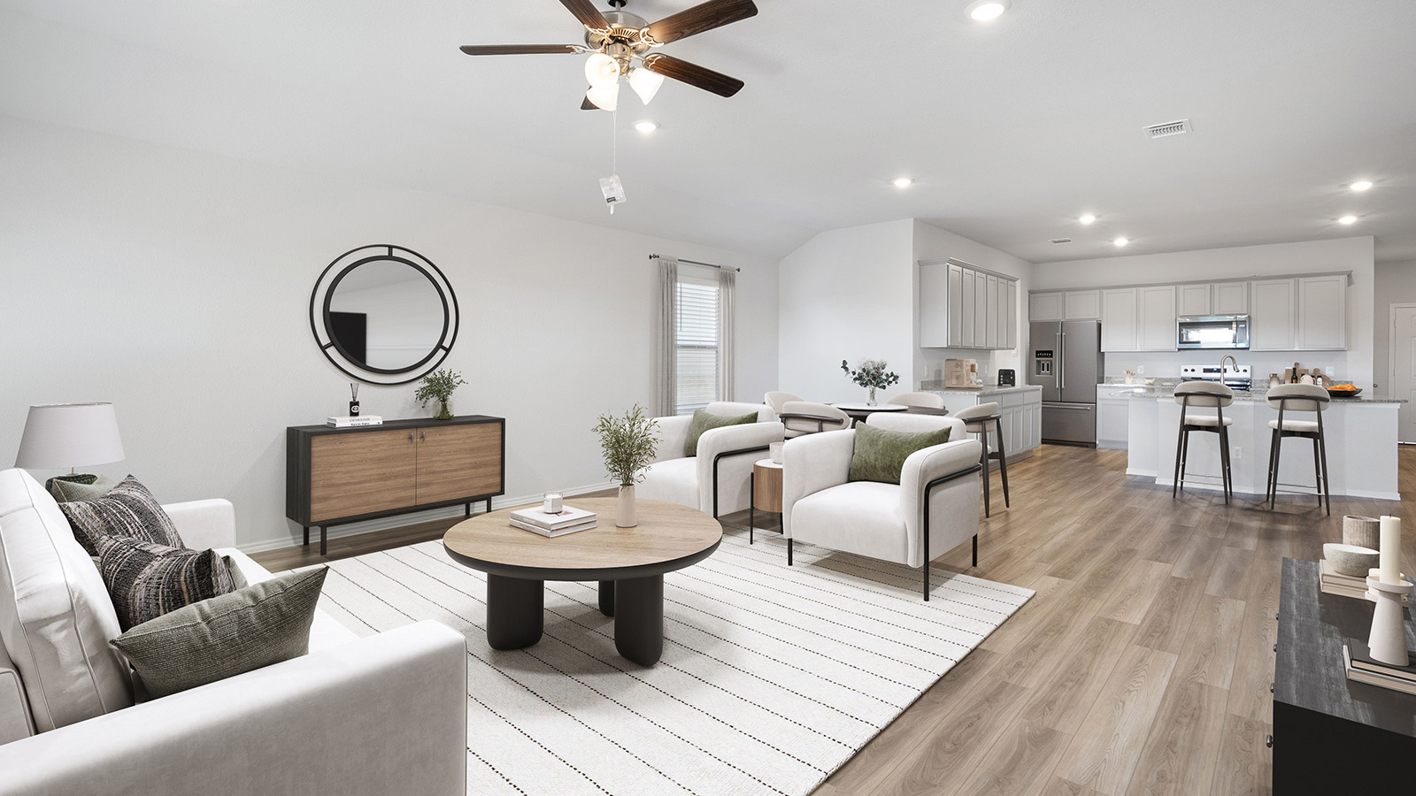 Creekside Hills model home living room with vinyl plank flooring with view of kitchen.