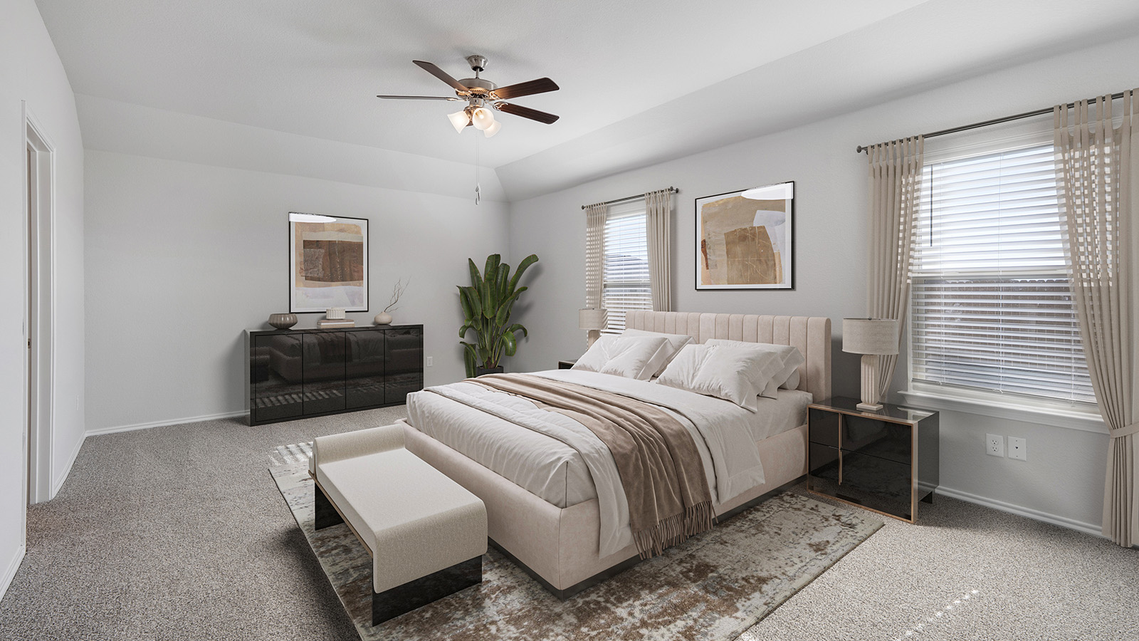 Creekside Hills model home primary bedroom with carpeted flooring and windows.