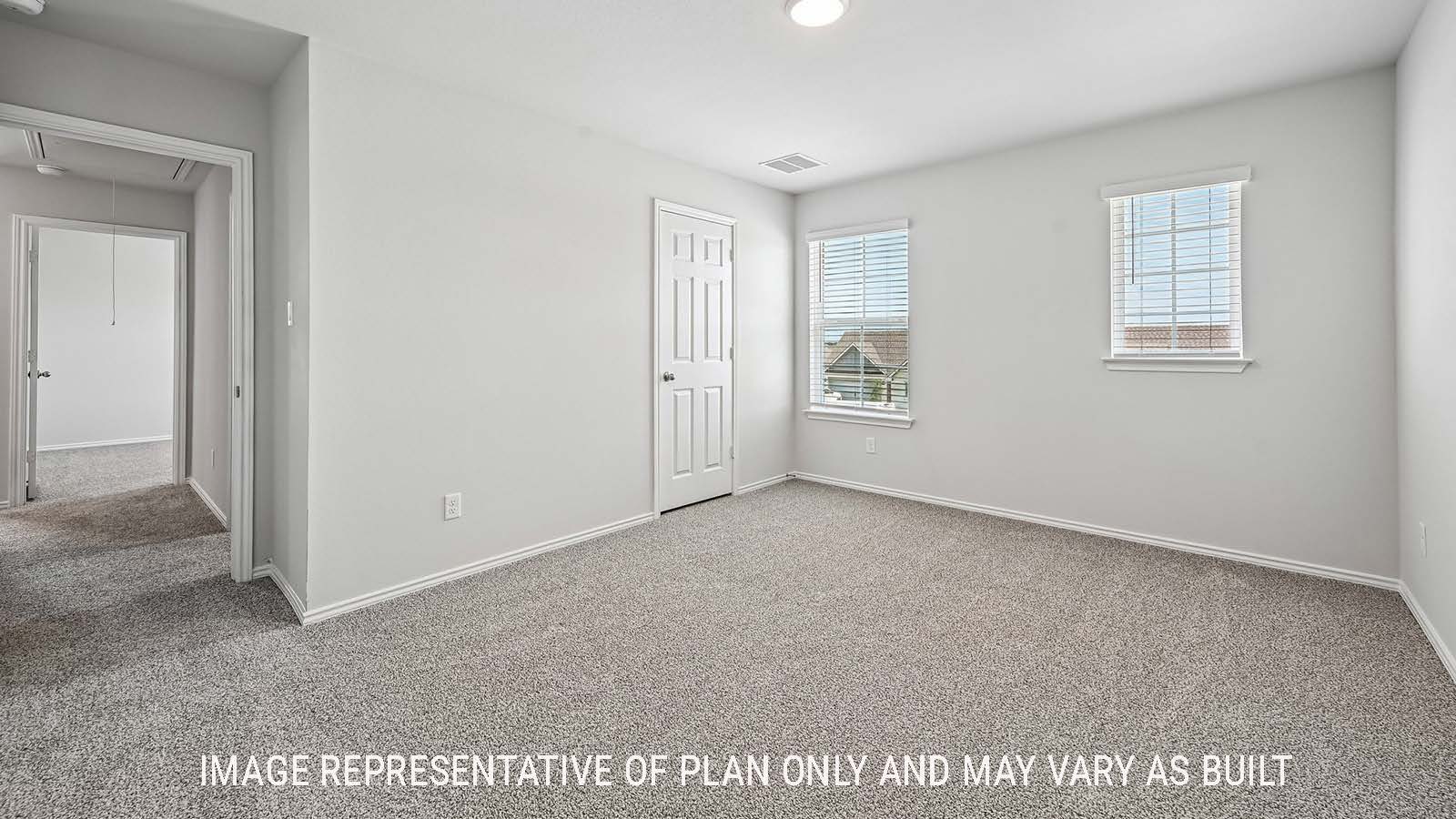 Madison secondary bedroom with carpeted flooring and windows for natural lighting.