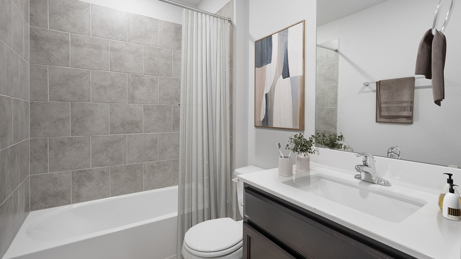 Creekside Hills model home secondary bathroom with single vanity sink and shower and tub combo.