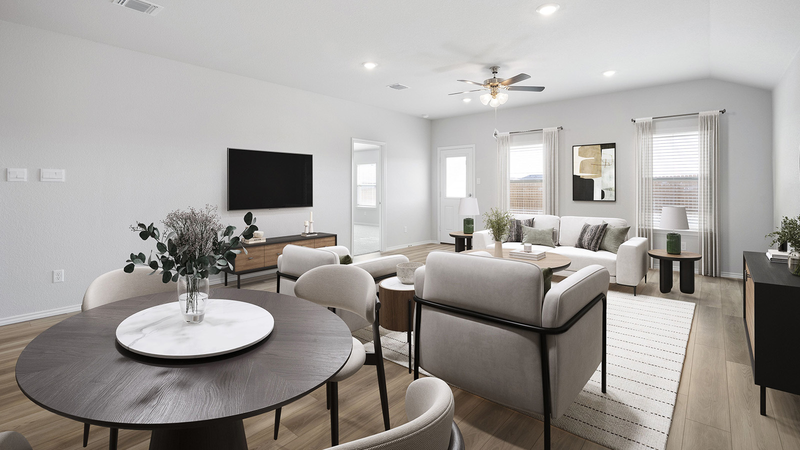 Creekside Hills model home living room with windows for natural lighting and view of back door.