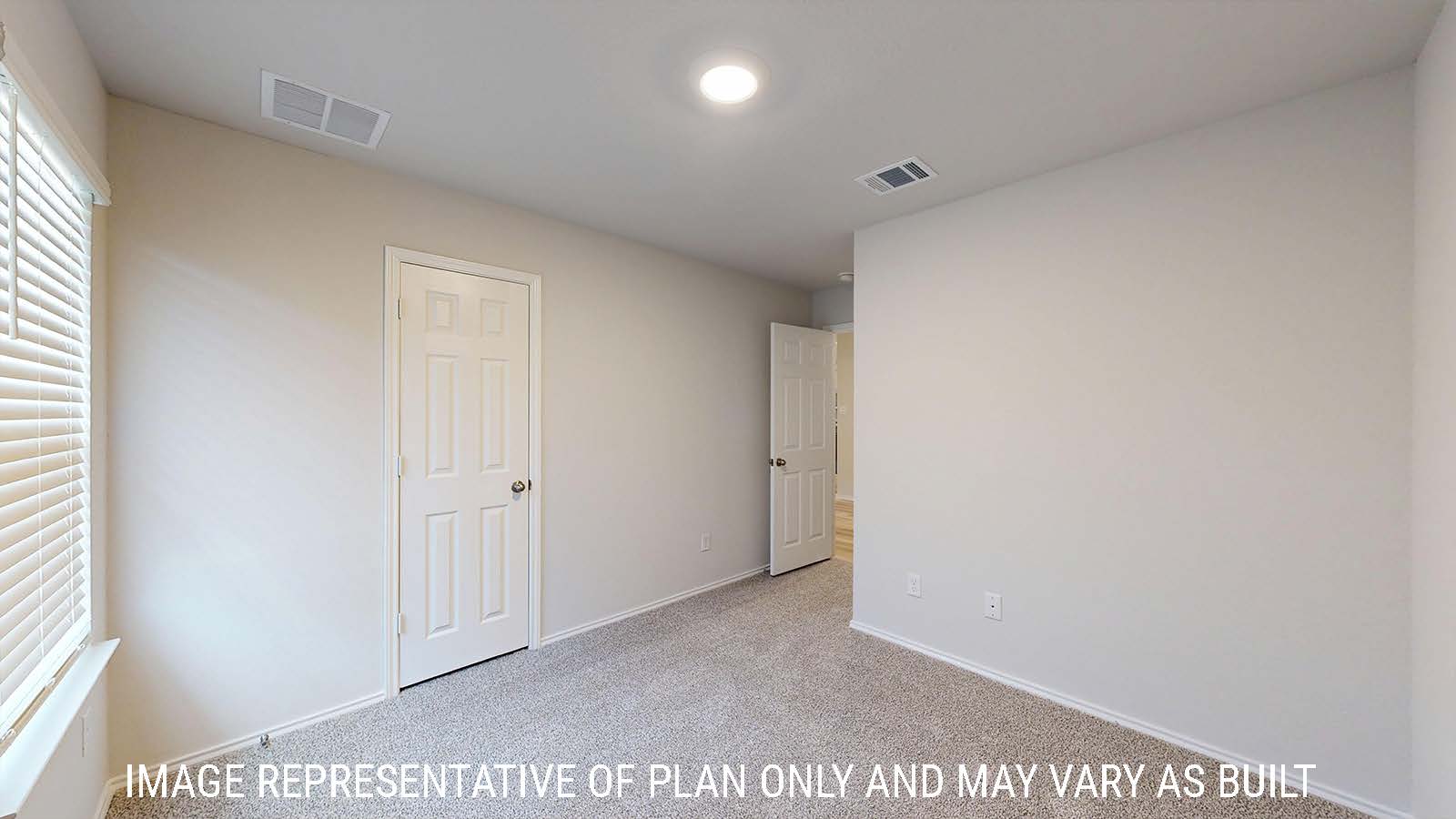 Harris secondary bedroom with carpeted flooring and window for lighting.