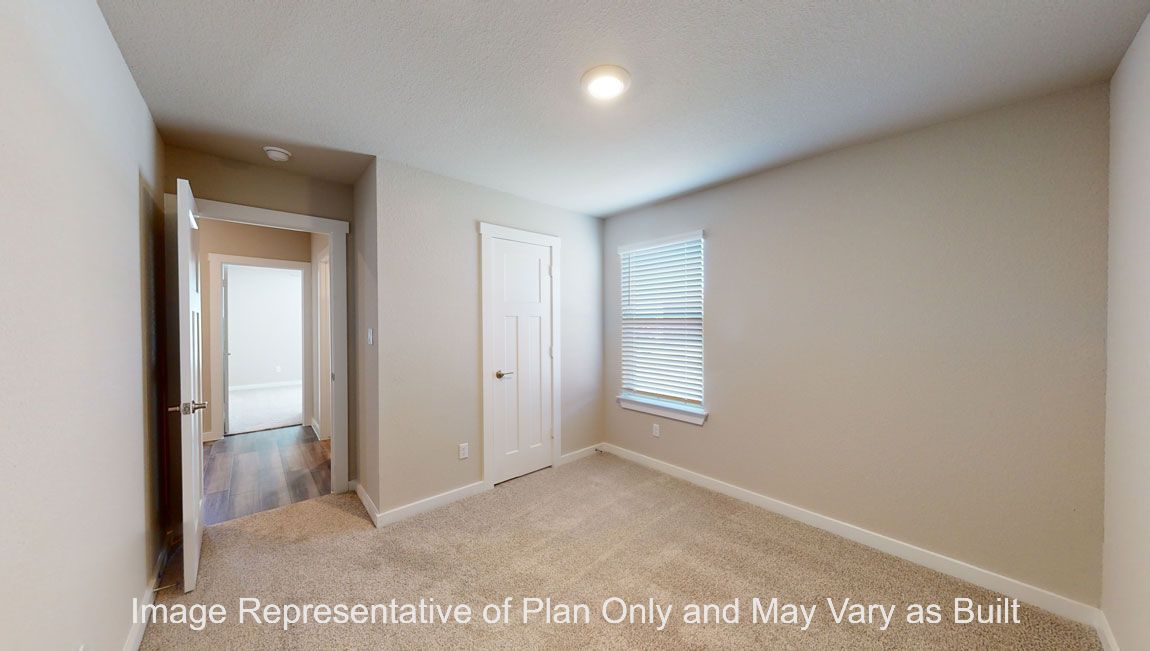 Harris secondary bedroom with carpet flooring and window near closet door.