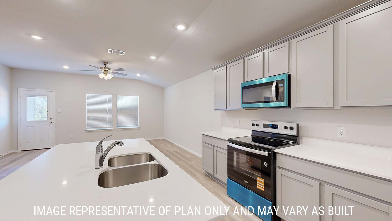 Harris kitchen with light cabinets and light countertops with view of dining room.