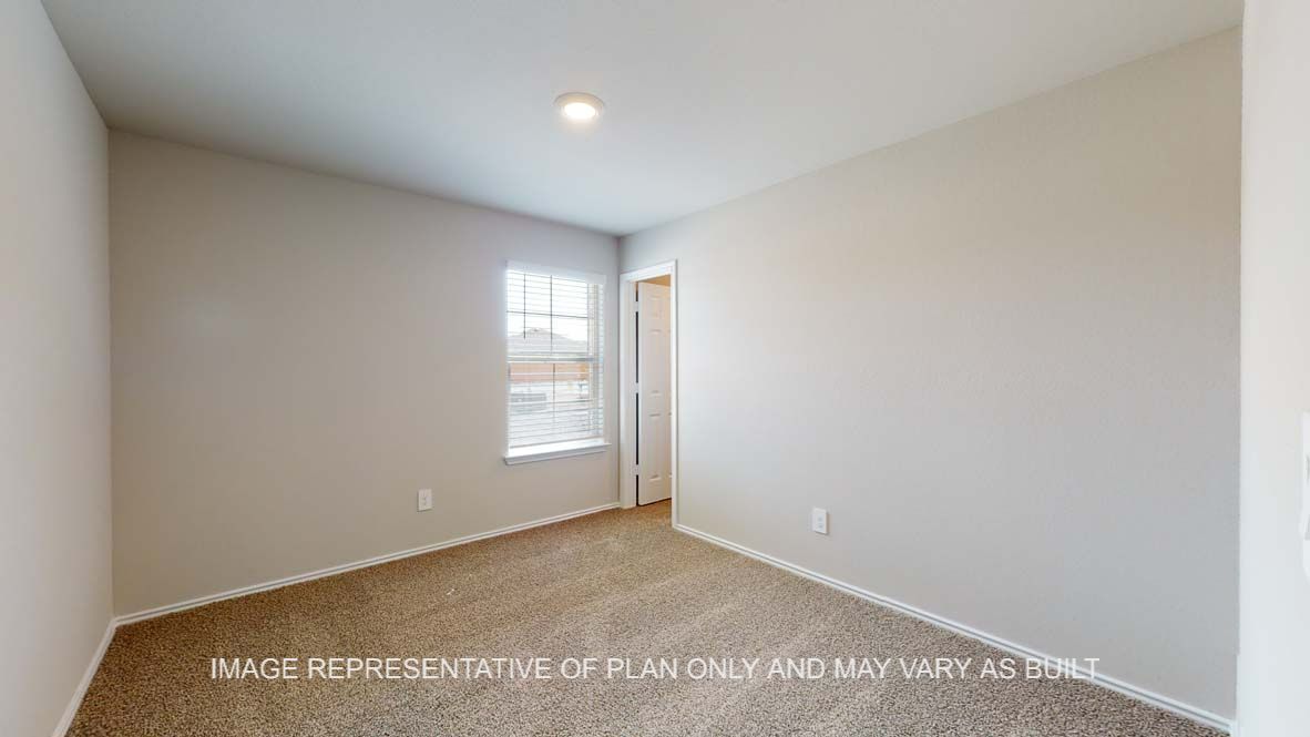 Bellvue secondary bedroom with carpet flooring and window.