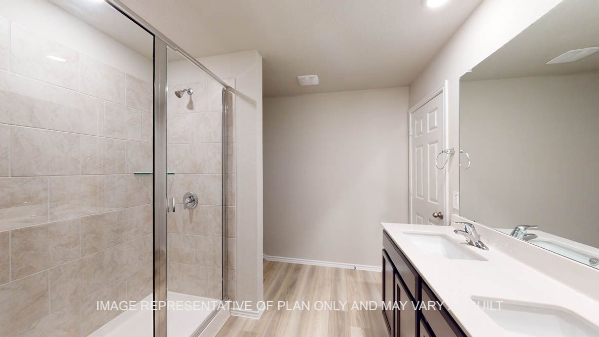 Camden primary bath with clear shower glass enclosure and ceramic tile surround on shower,