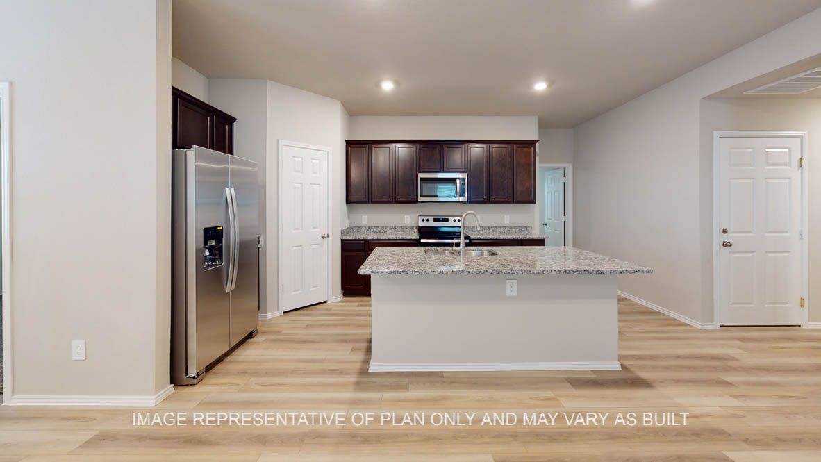 Camden kitchen with vinyl plank flooring, dark cabinets and granite countertops.