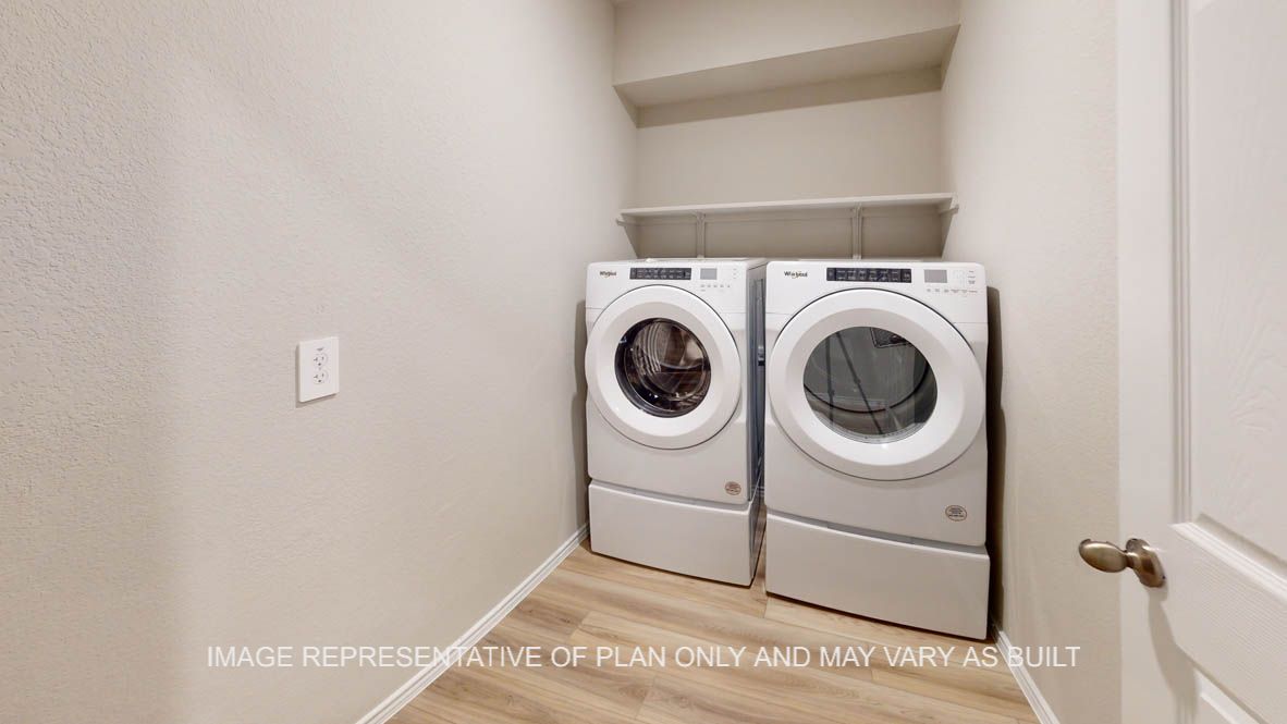 Camden utility room with vinyl plank flooring and front load washer and dryer.