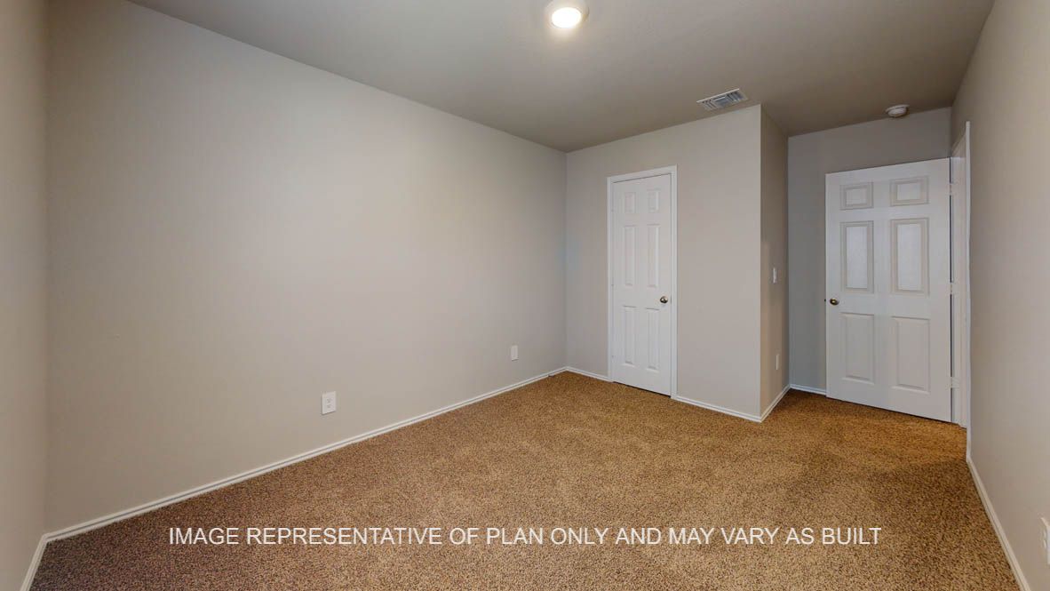 Elgin secondary bedroom with carpet flooring.