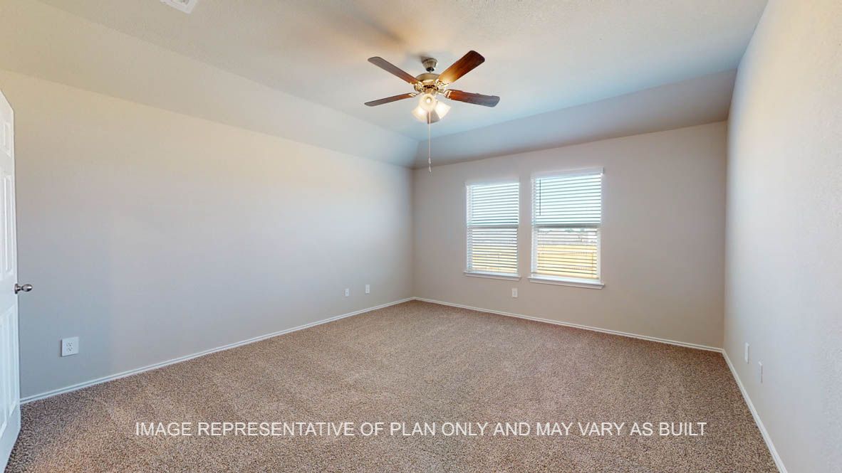 Fargo secondary bedroom with carpet flooring and window.