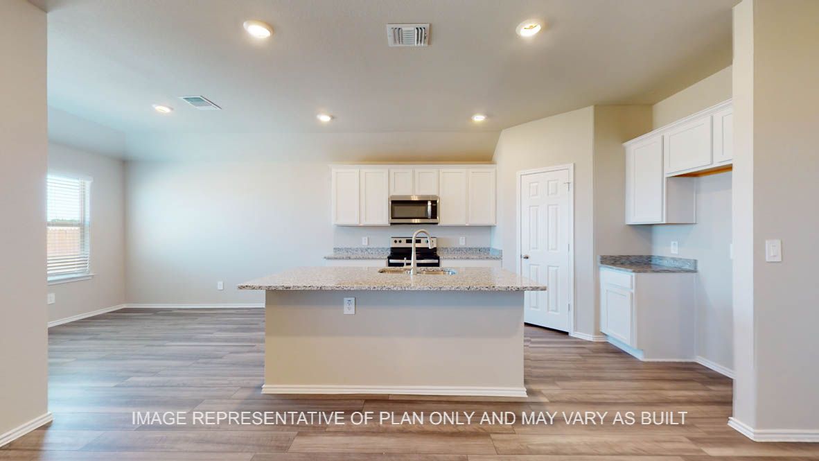 Fargo kitchen with large kitchen island and white cabinets.