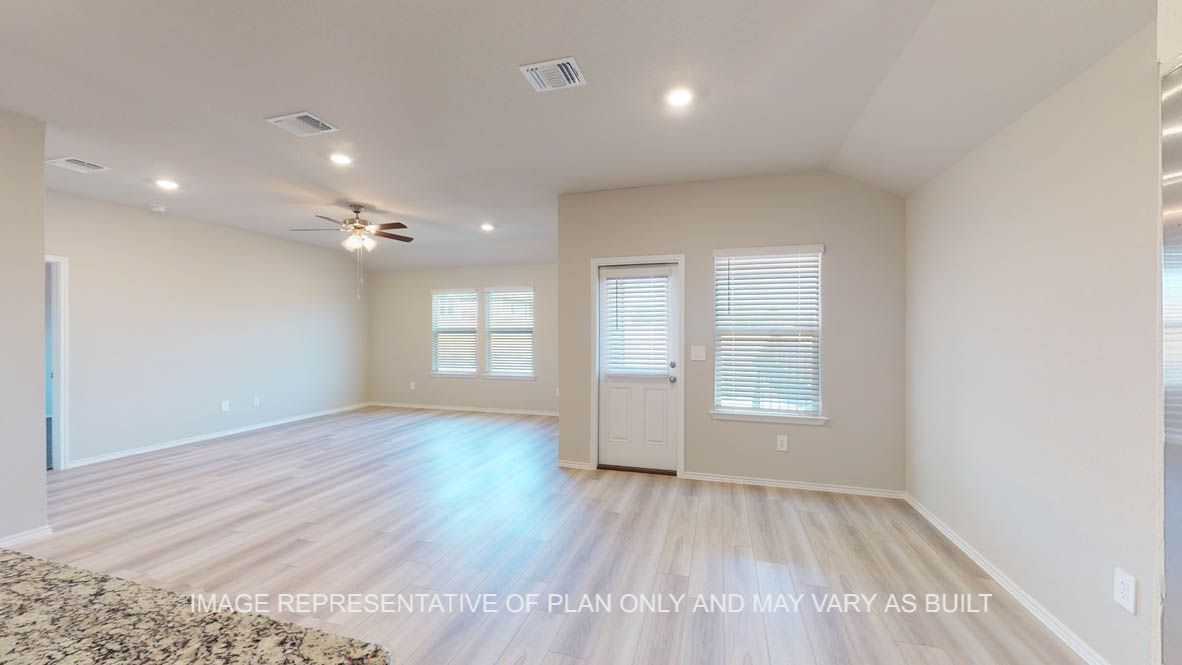 Texas Cali open concept dining room and living room with vinyl plank flooring throughout.