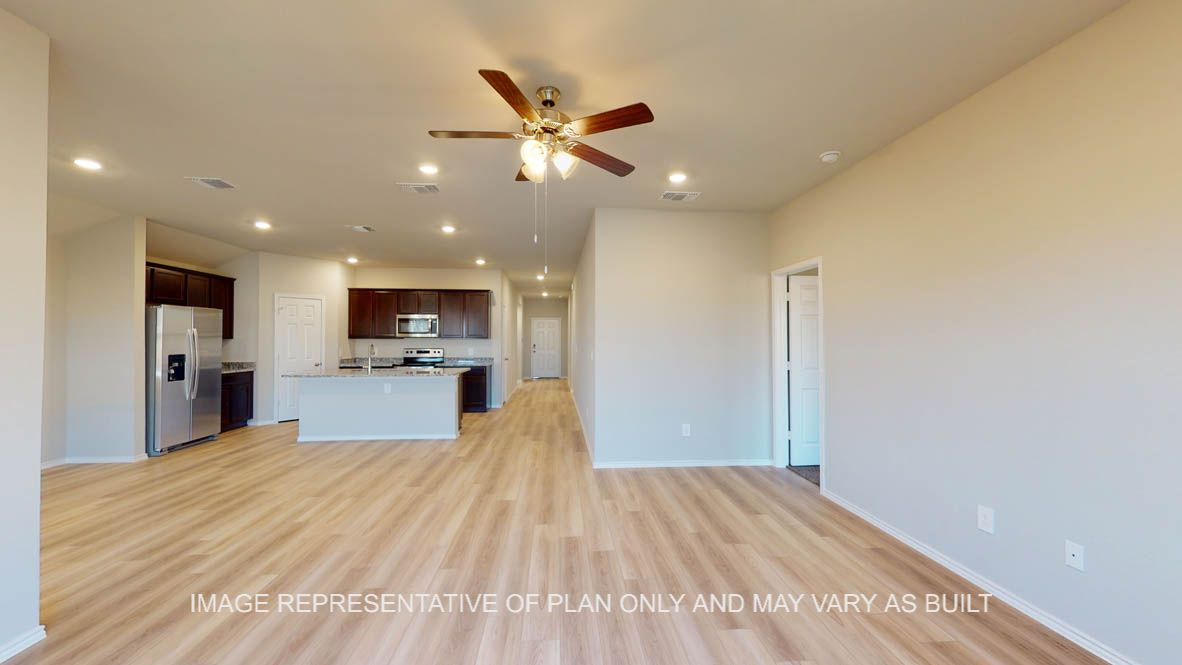 Texas Cali open concept dining room and living room with vinyl plank flooring throughout.