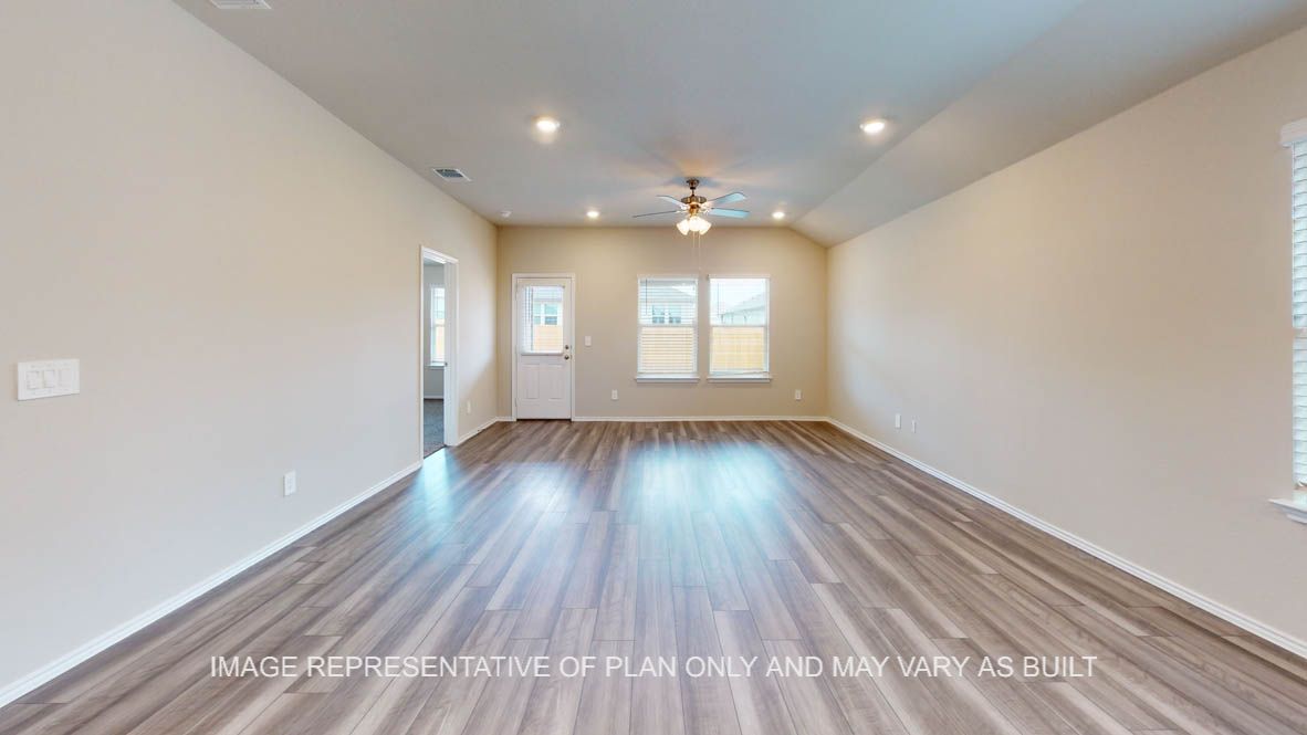 Elgin living room with vinyl plank flooring and windows to the backyard.