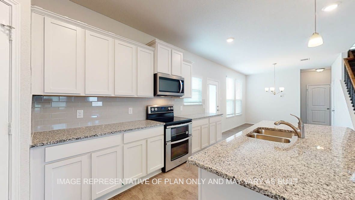 Aspen kitchen with white cabinets and granite countertops.