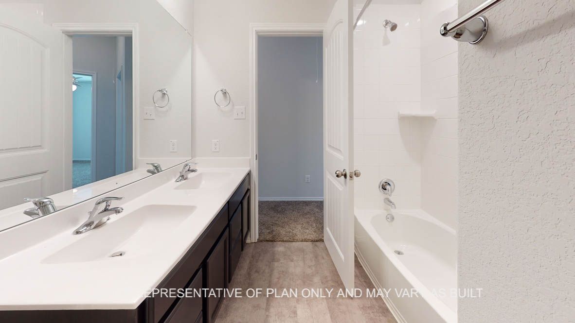 Aspen primary bath with white countertops and dark cabinets.
