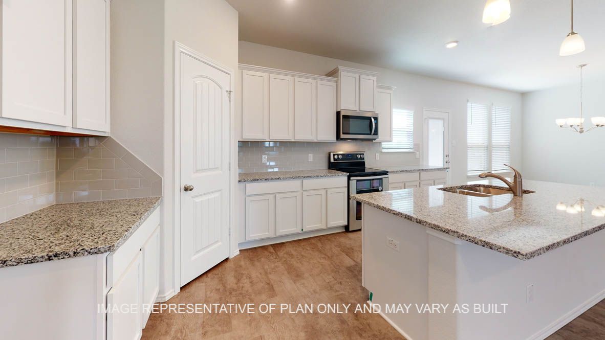 Aspen kitchen with white cabinets and vinyl plank flooring.
