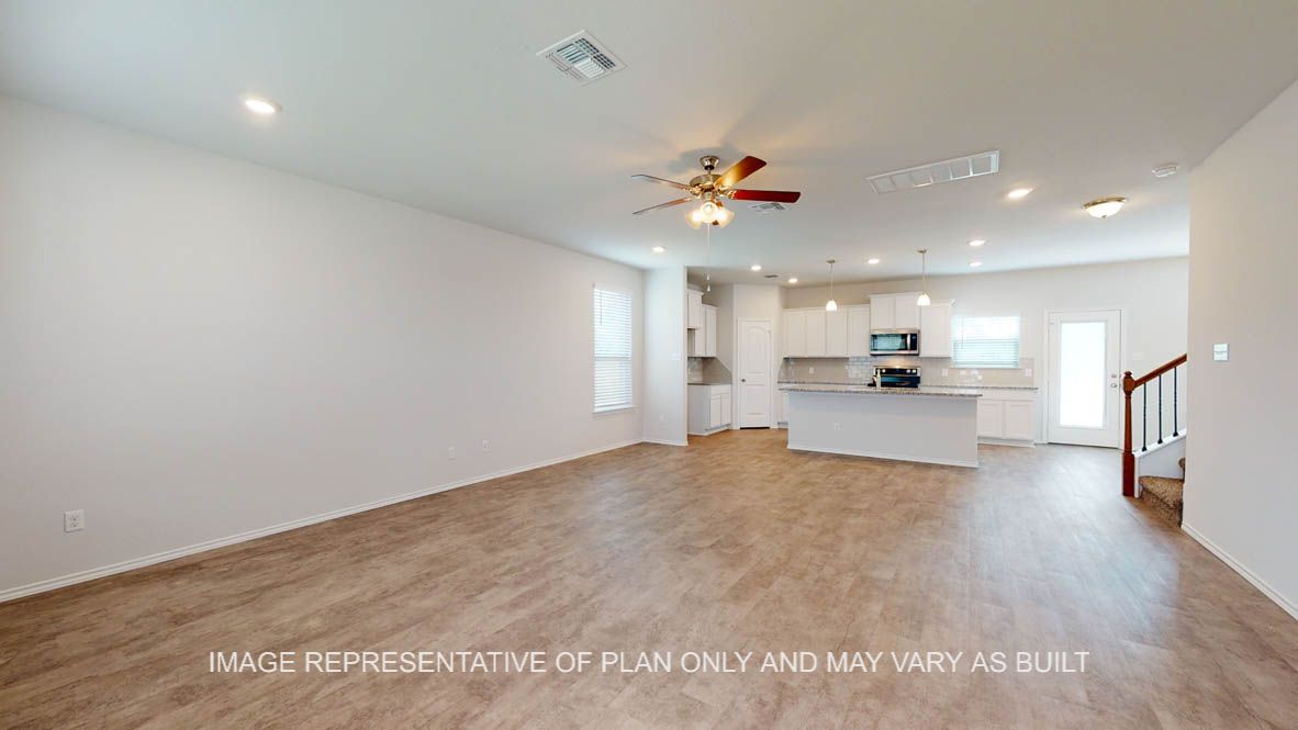 Aspen living room with vinyl plank flooring throughout and access to stairs.
