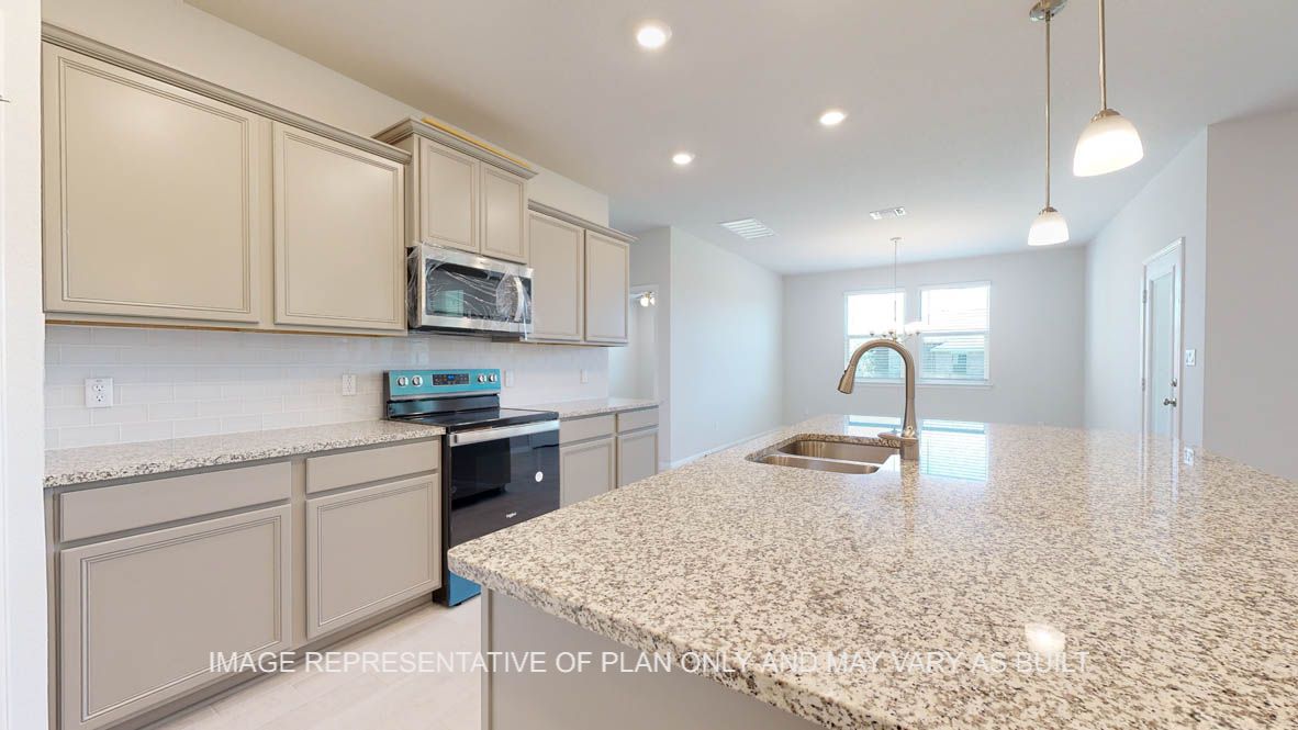 Parker kitchen with light griege painted cabinets, granite countertops and glass subway backsplash.
