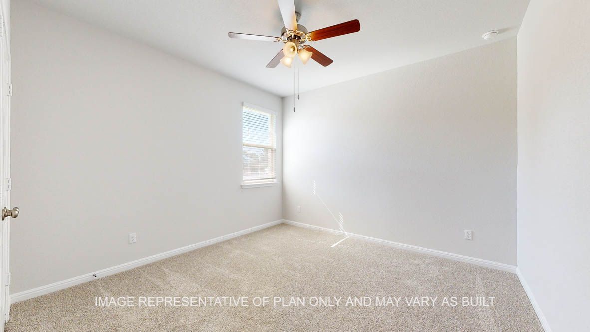 Parker secondary bedroom with carpet flooring and windows.