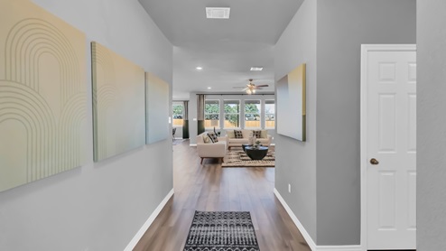 Village at Nolan Heights model home front entry with a view of the living room.