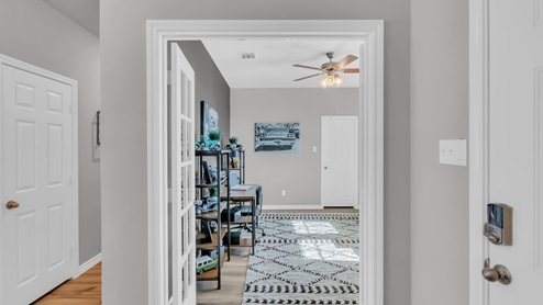 Village at Nolan Heights model home hallway entry with a view of the secondary bedroom.