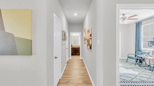 Village at Nolan Heights model home hallway entry with a view of the secondary bedroom.