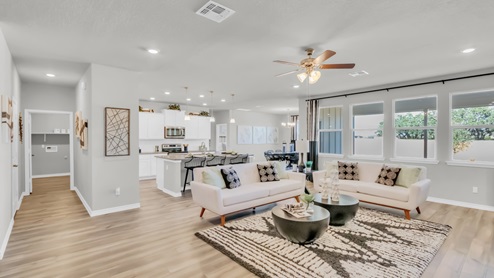 Village at Nolan Heights model home living room with open concept of dining room and kitchen.