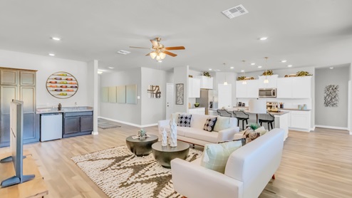 Village at Nolan Heights model home living room with open concept of dining room and kitchen.