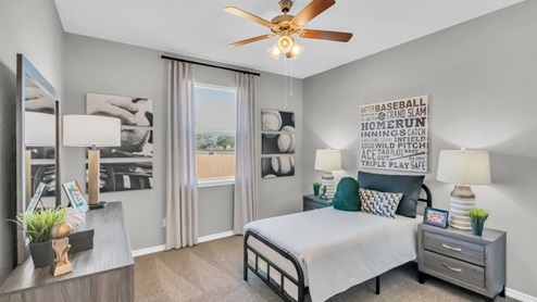 Village at Nolan Heights model home secondary bedroom with a twin bed and carpet flooring.