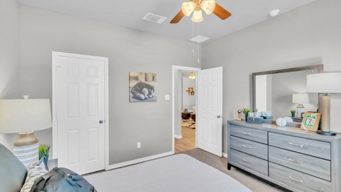 Village at Nolan Heights model home secondary bedroom with a twin bed and carpet flooring.