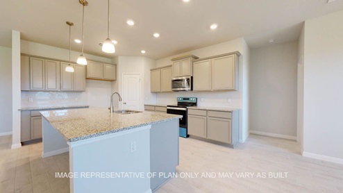 Parker kitchen with large island with light wood look tile flooring.