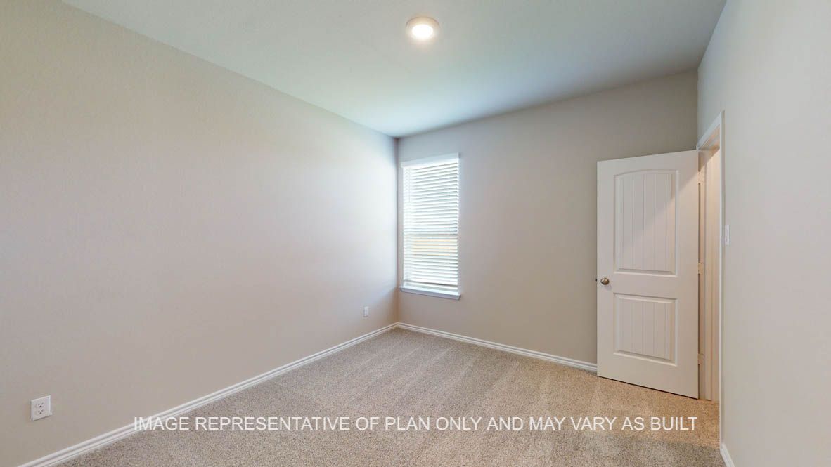 Sierra secondary bedroom with carpet flooring and walk-in closet.
