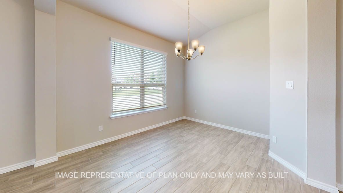 Sierra formal dining room with wood look tile flooring and light fixture.