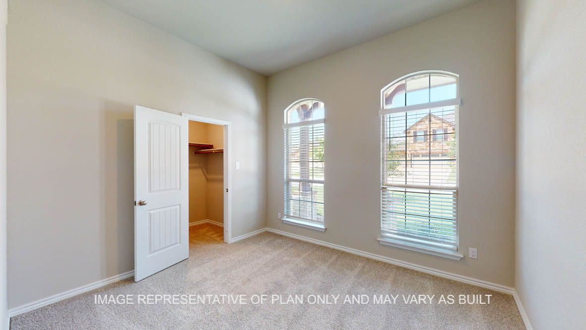 Sierra secondary bedroom with carpet flooring and windows with view to the front of the house.