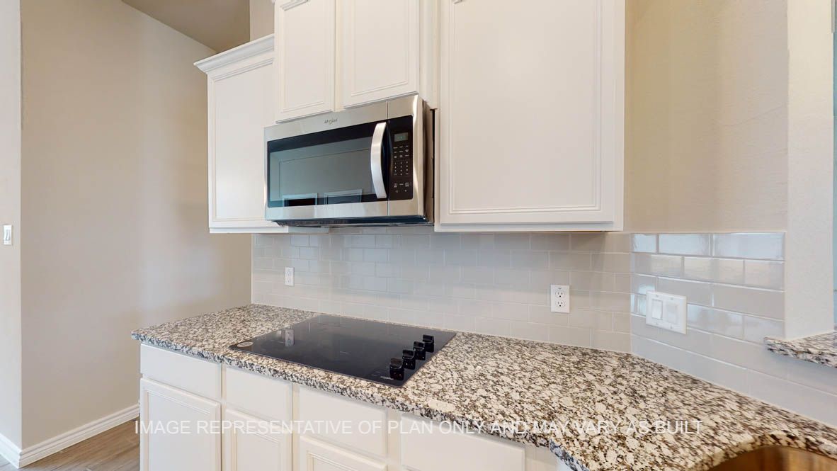 Sierra kitchen with white cabinets and granite countertops.